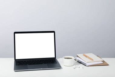 Workplace with laptop with empty screen for advertising