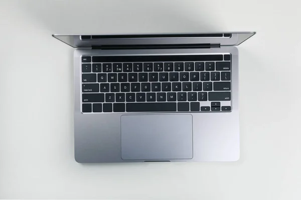 Open laptop on white background, top view