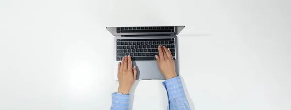 Female hands and laptop on white background, top view