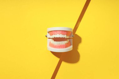 Concept of dental care on yellow background