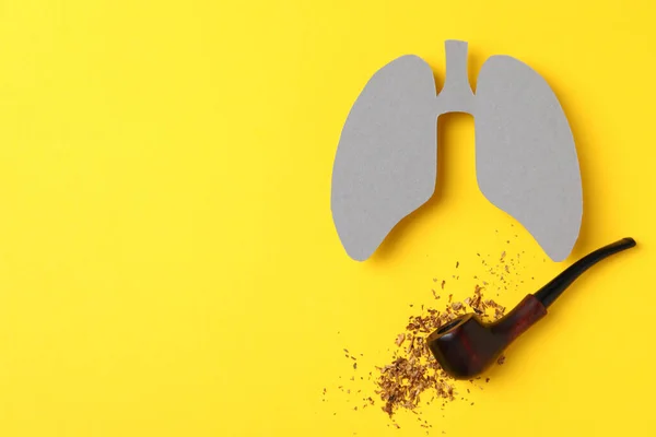 Lungs, smoking pipe and tobacco on yellow background, space for text