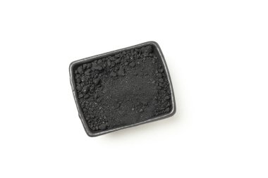 Bowl with powdered charcoal isolated on white background