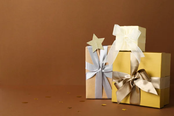 Concept of gift, gift boxes on brown background