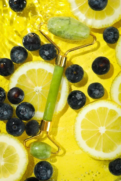 Blueberry, lemon and face roller in water