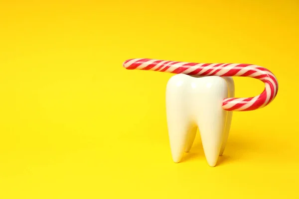 Concept of food bad for teeth on yellow background