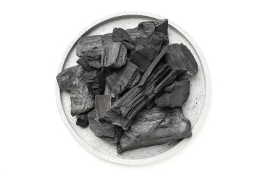 Tray with charcoal isolated on white background