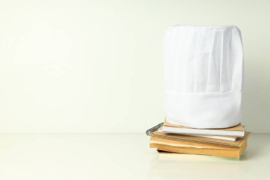 Composition with chef hat for concept of cooking, space for text