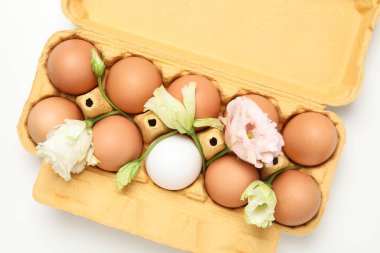 Concept of spring, eggs with flowers, top view