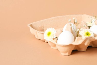 Concept of spring, eggs with flowers, space for text