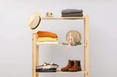 Wooden shelving with clothes, autumn season clothes