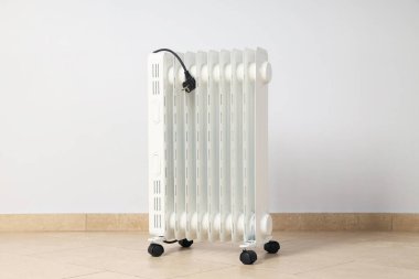 Concept of heating season, modern electric heater in room
