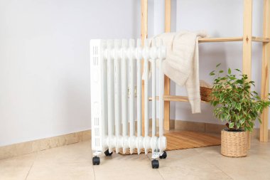 Concept of heating season, modern electric heater in room
