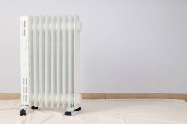 Concept of heating season, modern electric heater in room