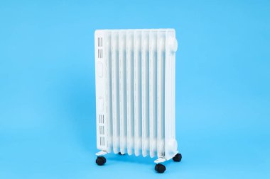 Modern white electric heater on blue background