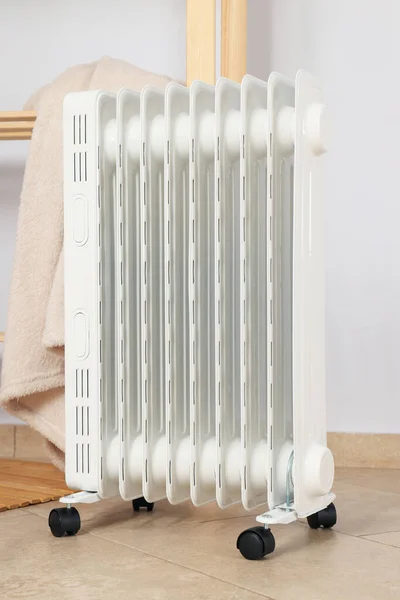 Concept of heating season, modern electric heater in room