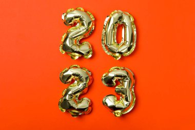 Concept of Happy New Year, 2023 numbers on orange background