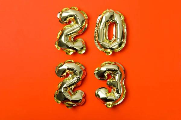 Concept of Happy New Year, 2023 numbers on orange background
