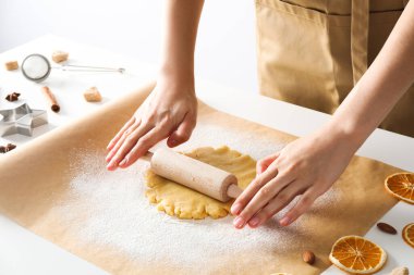 Woman cooking cookies, using cookie cutter and rolling pin