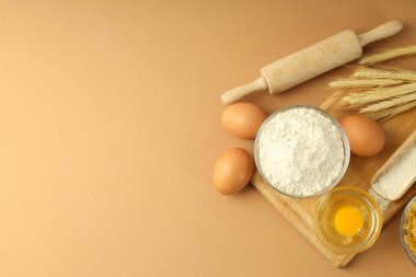 Concept of cooking with ingredients on beige background, space for text