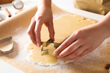 Woman cooking cookies, using different cookie cutters