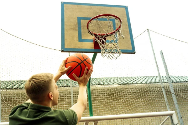 Man throw the ball in basketball hoop