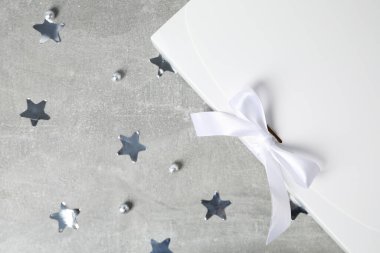 Concept of winter gift, gift box and accessories on gray textured table