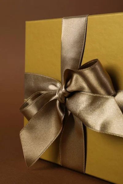 Concept of gift, gift box on brown background