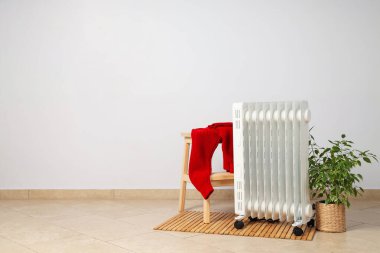 Concept of heating season, modern electric heater in room