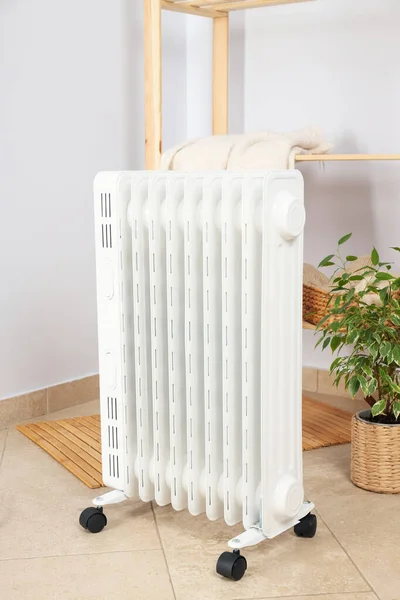 Concept of heating season, modern electric heater in room