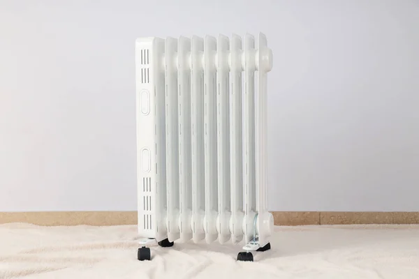 Concept of heating season, modern electric heater in room