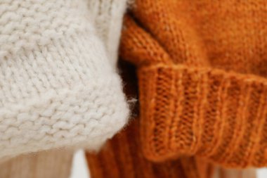 Hanging sweaters, concept of autumn season clothes