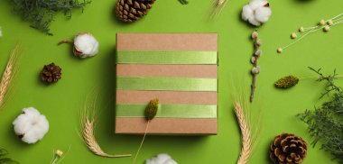 Concept of gift, gift box and accessories on green background