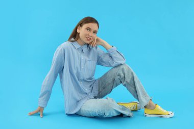 Concept of people, young woman on blue background