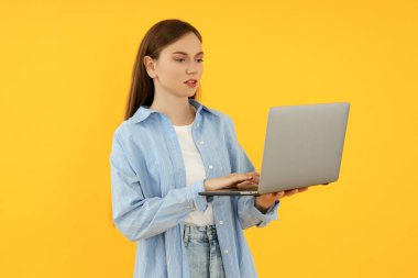Concept of people, young woman on yellow background