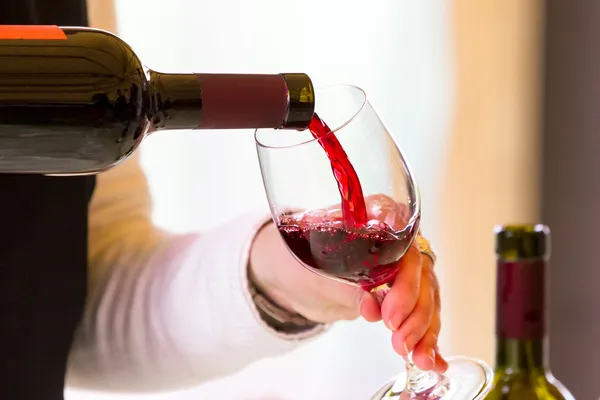 Waiter pouring red wine — Stock Photo, Image