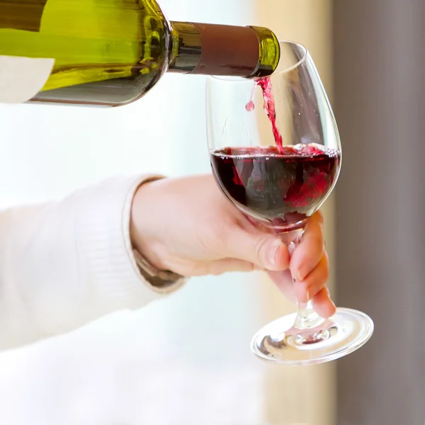 Официант наливает красное вино — стоковое фото