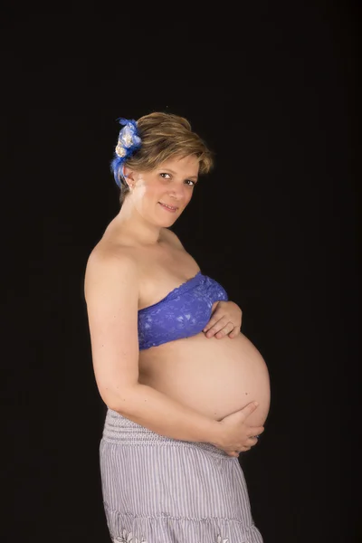 Pregnant belly on black background — Stock Photo, Image