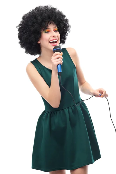 Woman with afro hairstyle doing karaoke Stock Photo