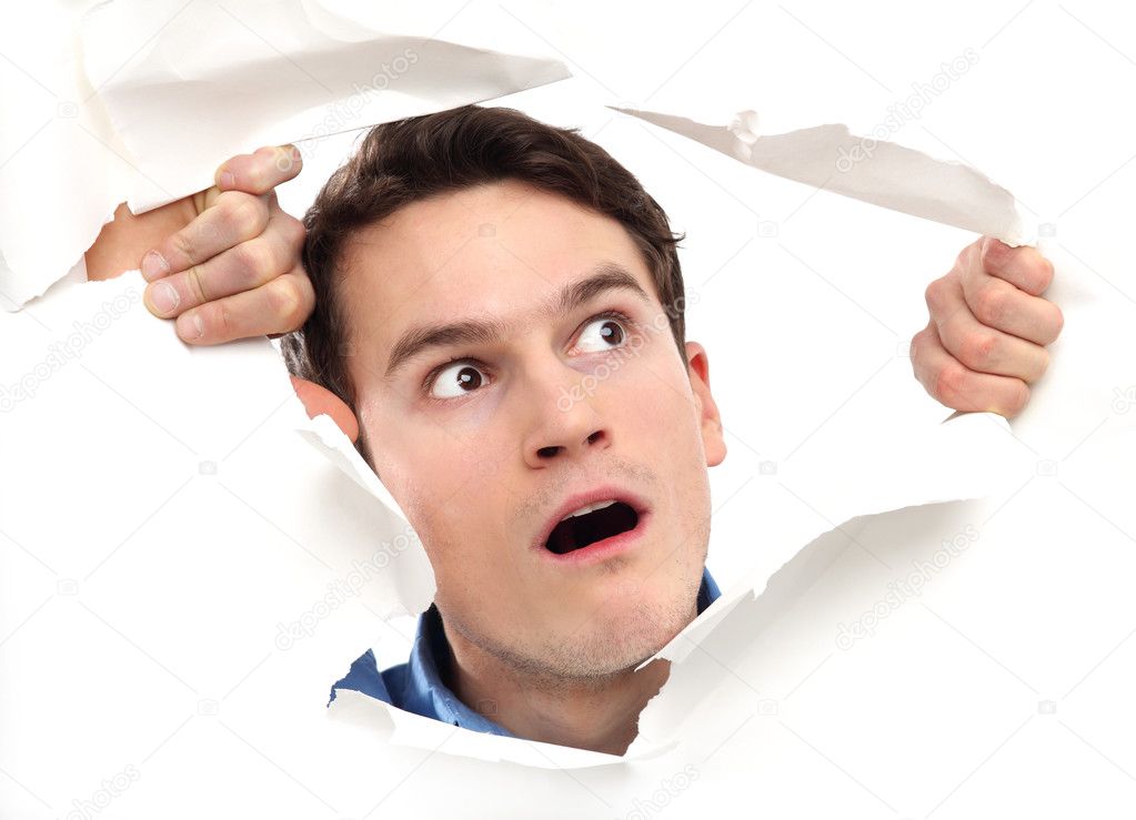 man looking through paper hole