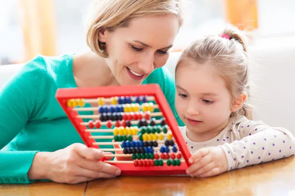 Mother and daughter with abacus Royalty Free Stock Images