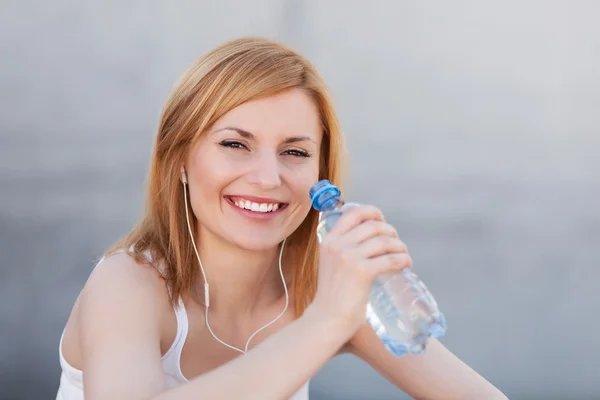 Νεαρή γυναίκα με μπουκάλι νερό — Φωτογραφία Αρχείου