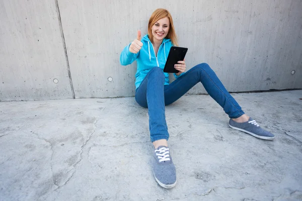 Mujer joven con tableta digital mostrando los pulgares hacia arriba —  Fotos de Stock