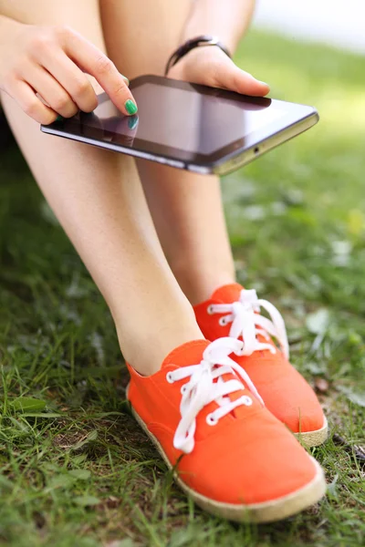 Woman using digital tablet outdoors — Stock Photo, Image