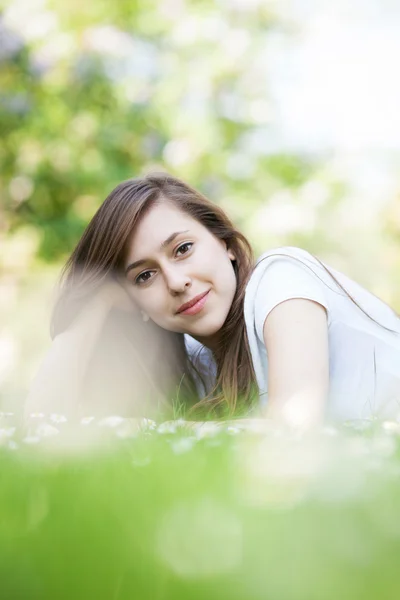 Female lying down on the grass — Stock Photo, Image