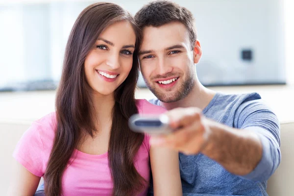Couple with TV remote — Stock Photo, Image