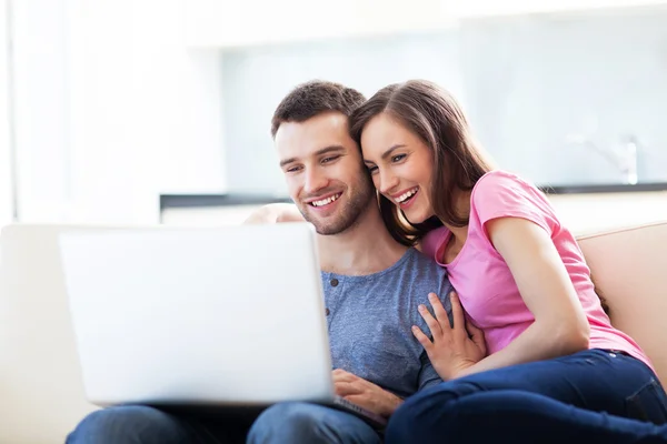 Couple sur canapé avec ordinateur portable — Photo