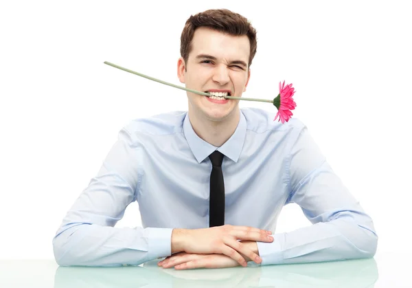 Businessman biting flower — Stock Photo, Image