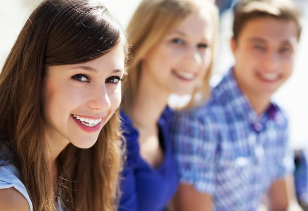 Three young friends standing together — Stock Photo, Image
