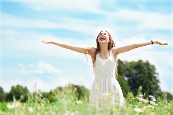 Woman in meadow holding scarf — Stock Photo, Image