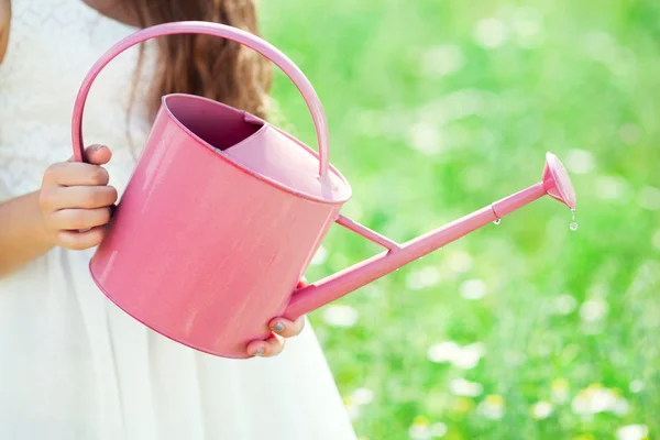 Woman watering flowers — Stock Photo, Image